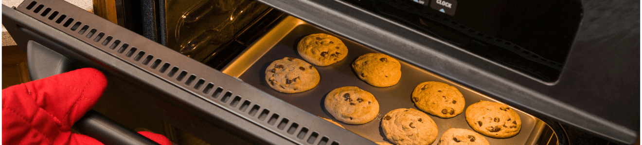 Close up of cookies baking in an oven.
